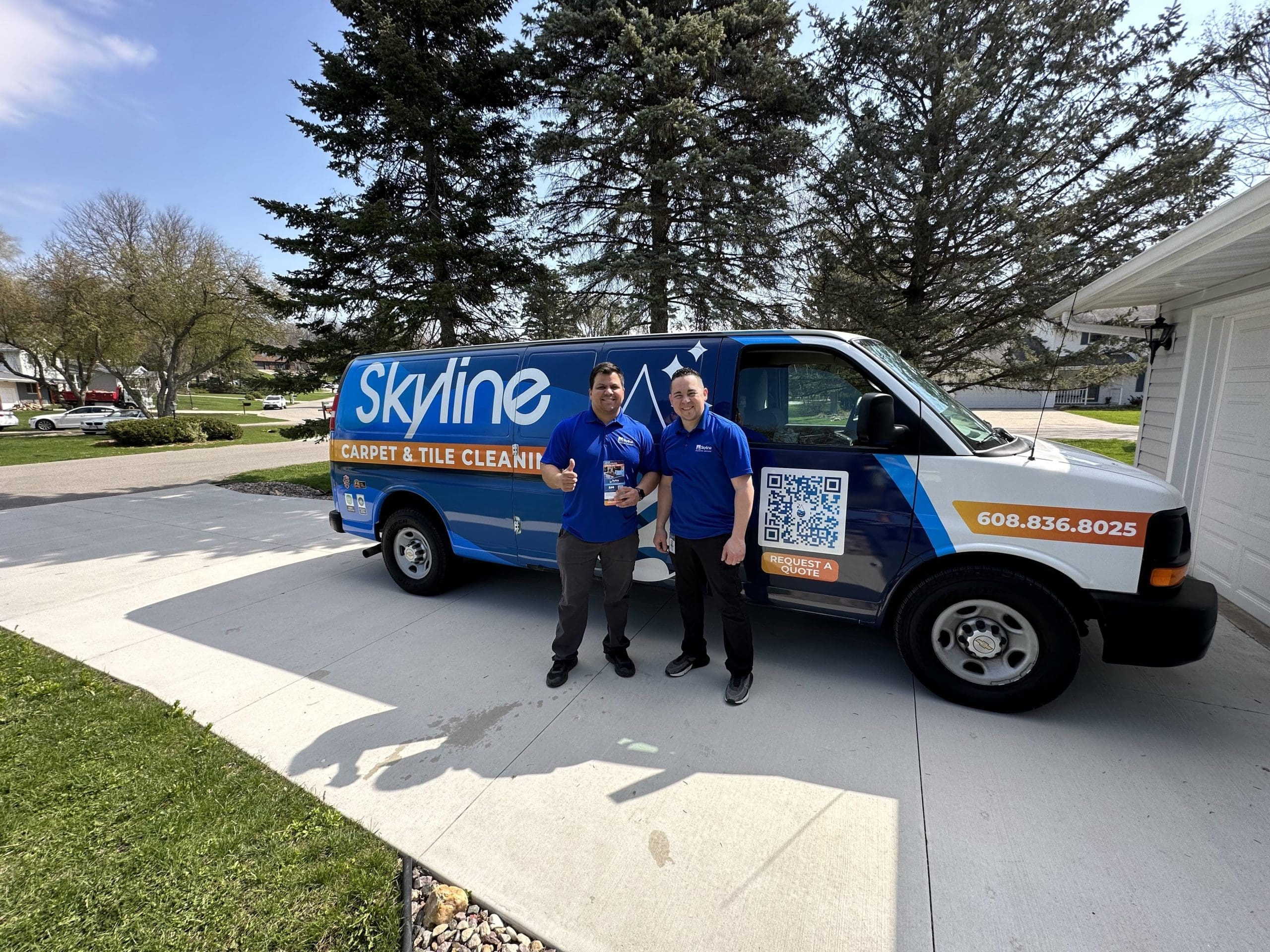 2 cleaners in front of a van
