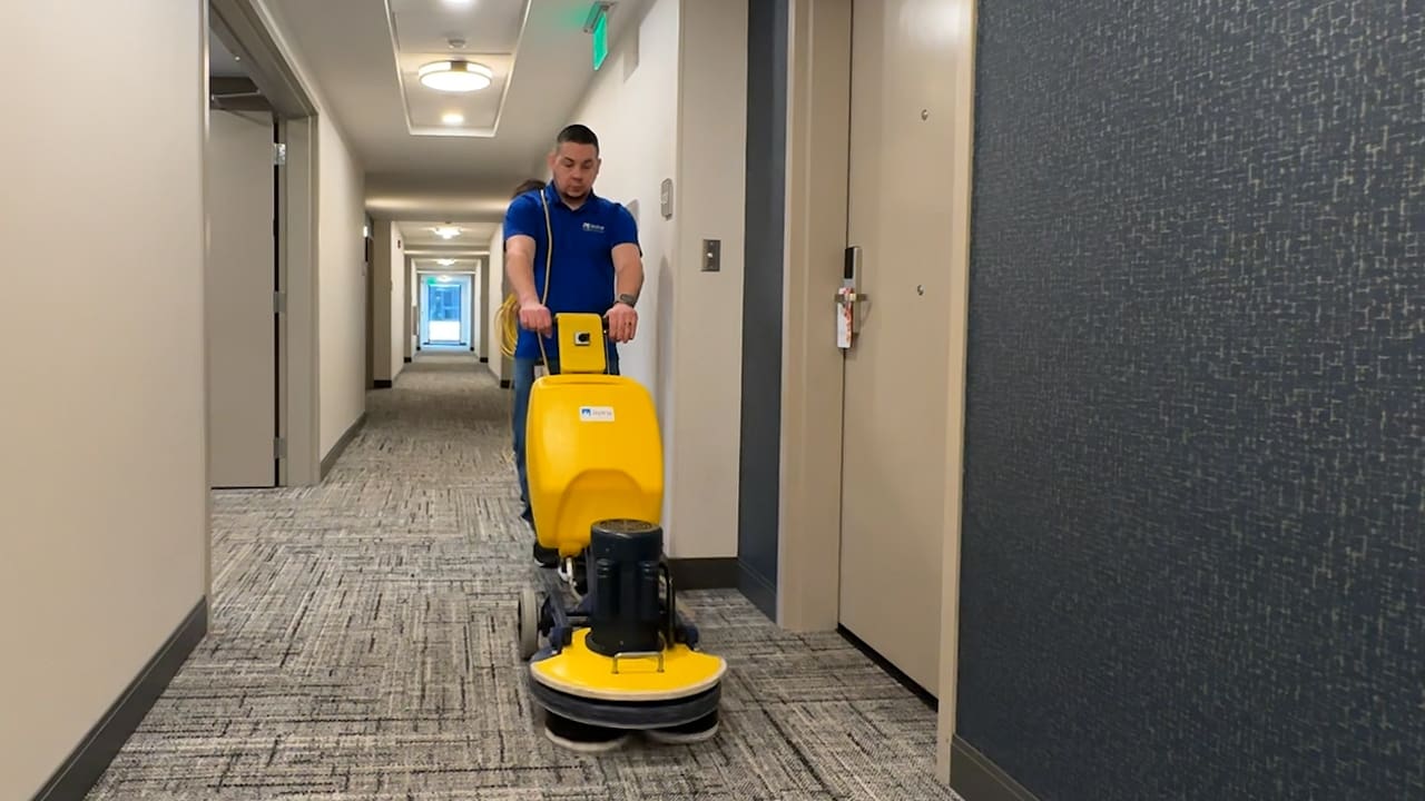 2 men using carpet cleaning machine