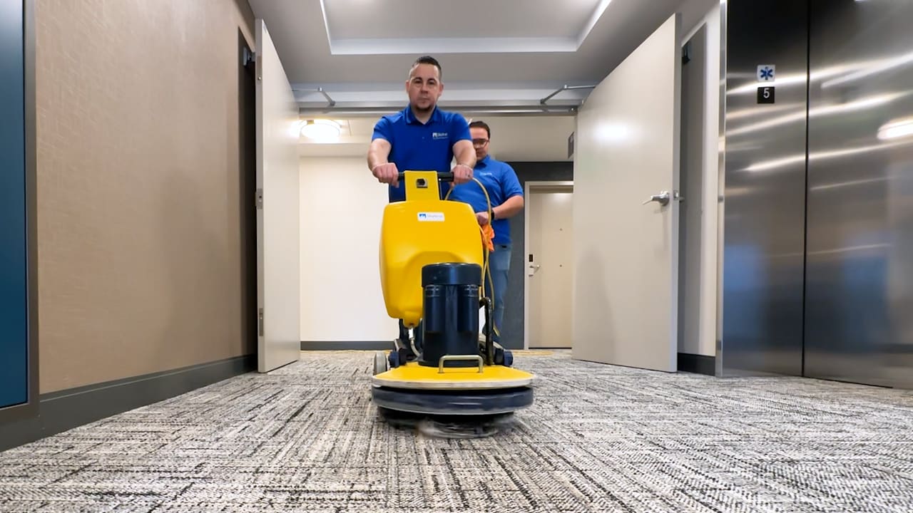 2 men using carpet cleaning machine
