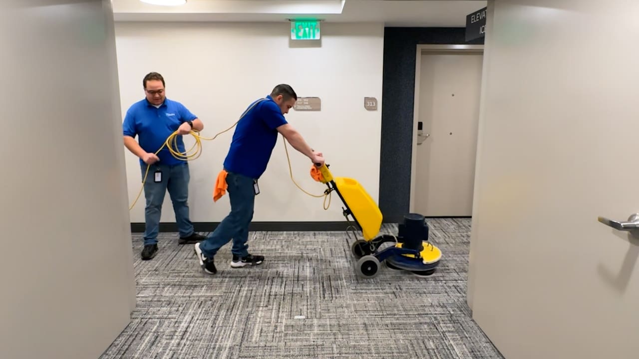 2 men using carpet cleaning machine