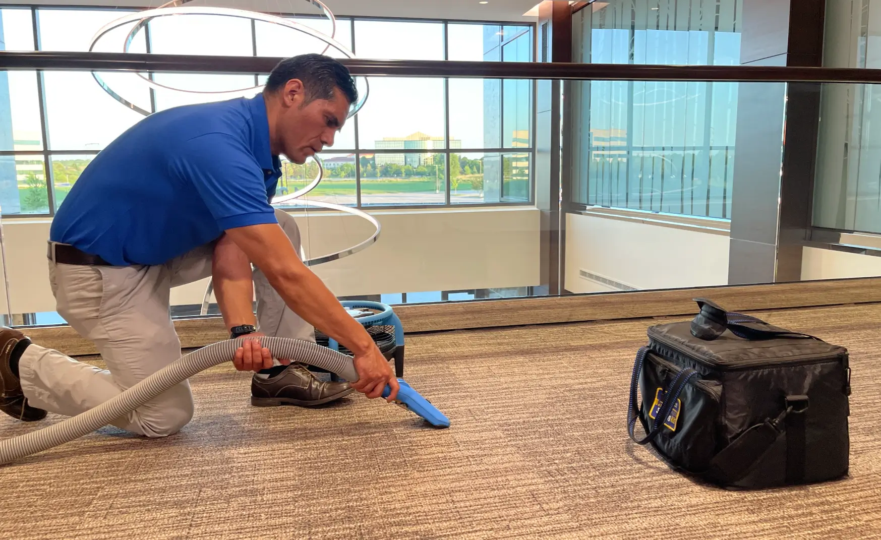 2 men using carpet cleaning machine