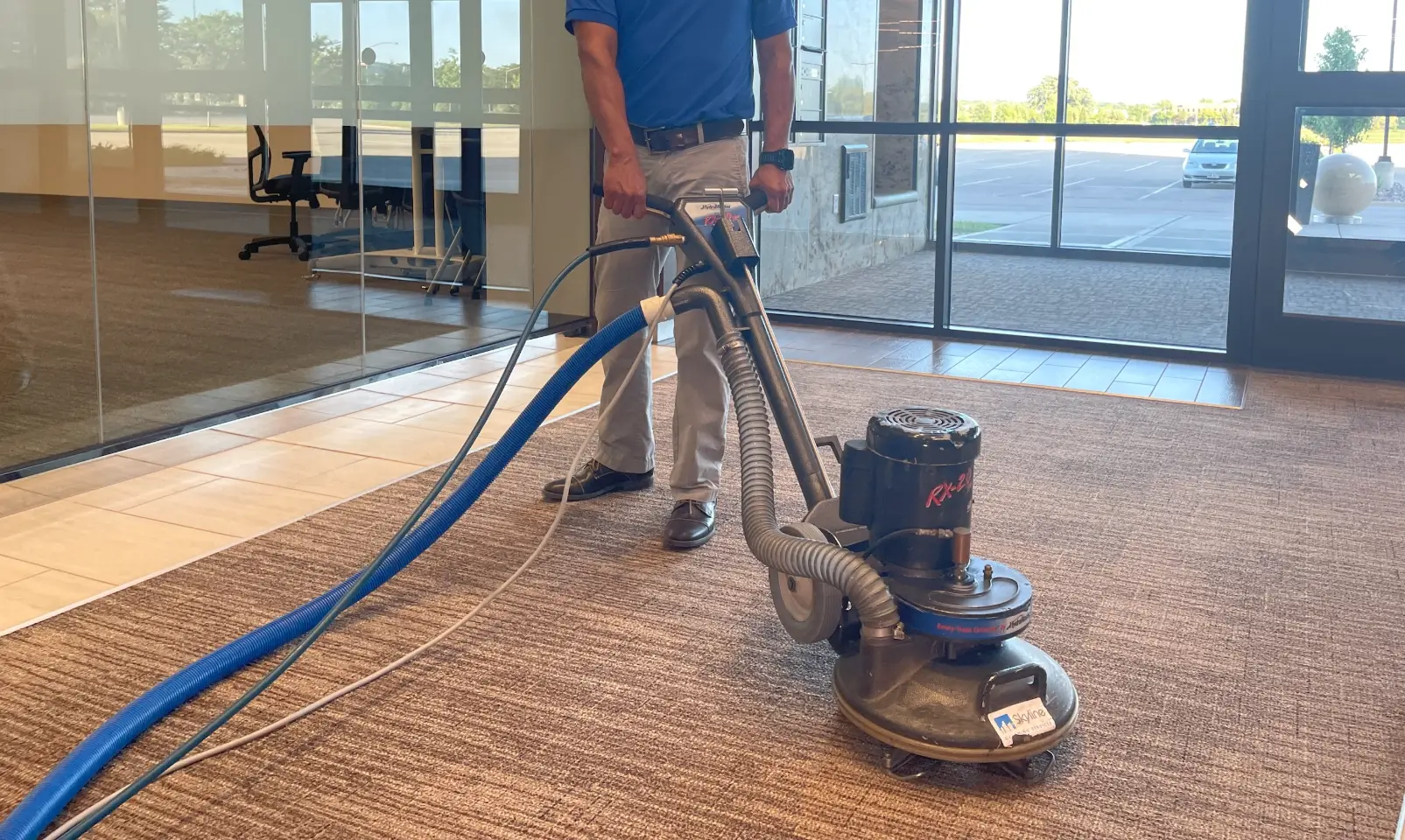 2 men using carpet cleaning machine
