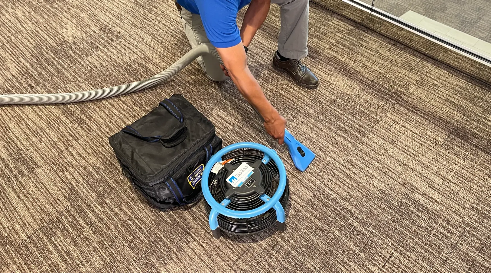 2 cleaners in front of a van
